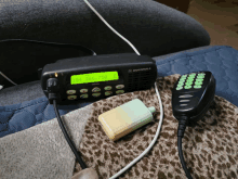 a motorola radio is sitting on a couch next to a microphone