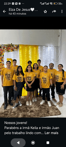 a group of people standing in front of a yellow curtain with the words elza de jesus at the top