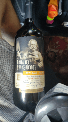 a bottle of wine with a man holding a pipe on it