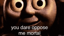 a close up of thomas the tank engine 's face with the words `` you dare oppose me mortal '' written on it .