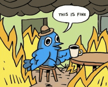 a blue bird is sitting at a table with a cup of coffee and a speech bubble that says " this is fine "