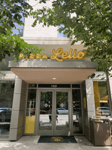 a building with a sign that says pizza leila above the entrance