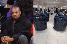 a man in a hoodie sits next to a pile of garbage bags in a store