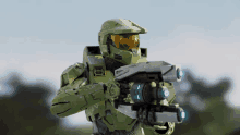 a man in a green helmet is holding a weapon