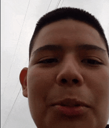 a close up of a person 's face with a few wires behind him