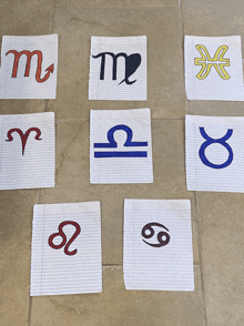 several pieces of paper with zodiac signs written on them