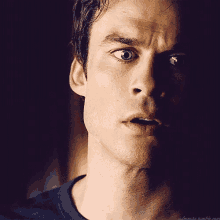 a close up of a man 's face with a dark background and a tumblr link