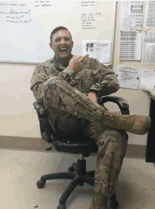 a man in a military uniform sits in a chair