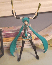 a figurine of hatsune miku is holding up two green onions