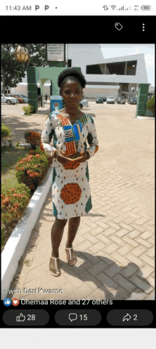 a woman in a dress is standing in front of a building with the time of 11:43