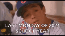 a baseball player wearing a cubs hat is sitting in a dugout with the words `` last monday of 2021 school year '' .