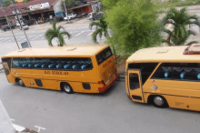 a yellow bus with the word sekolah on the side of it