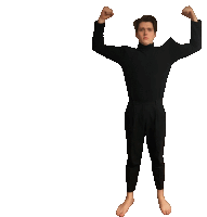 a man in a black sweater is flexing his arms