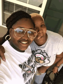 two women posing for a picture one wearing a t-shirt that says nba on it