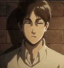 eren yeager from attack on titan is standing in front of a brick wall and making a funny face .