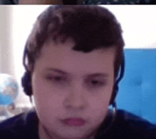 a close up of a person wearing headphones on a video call .