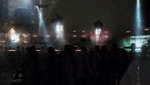 a group of people are standing in a dark room with a helicopter flying overhead