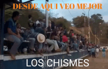 a group of people sitting on a wall with the words los chismes on the bottom