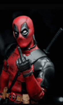 deadpool is giving the middle finger to the camera .