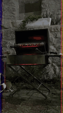 a barbecue grill is lit up in front of a stone wall with a rainbow colored border