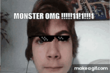 a young man wearing sunglasses with the words monster omg on his face