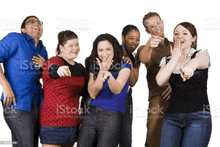 a group of young people are laughing and pointing at the camera royalty - free