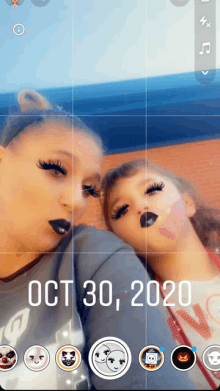 a woman and a little girl are taking a picture on october 30th 2020