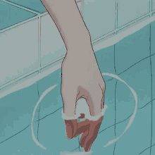 a person 's hand is sticking out of a pool of water .