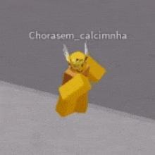 a roblox character wearing a yellow helmet and horns is standing on the ground .