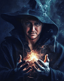 a man in a hooded jacket holds a light in his hands