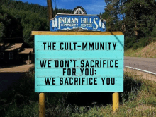 a sign for the indian hills community center says " the cult-mmunity we don 't sacrifice for you we sacrifice you "