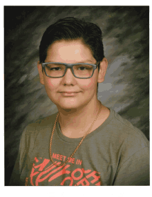 a young boy wearing glasses and a t-shirt that says meet me in