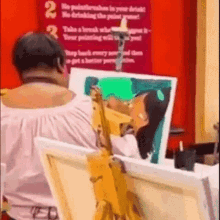 a woman is painting a picture of a woman on a canvas in front of a red sign .