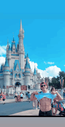 a shirtless man is standing in front of a castle