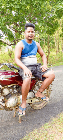 a man is sitting on a red motorcycle with the word bullet on the tank