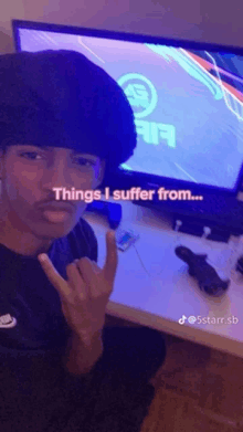 a young man is sitting in front of a tv with the words things i suffer from