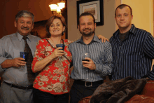 a group of people posing for a picture with two men and a woman