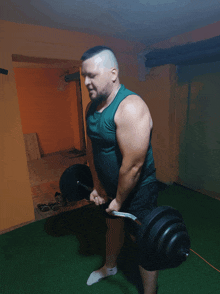 a man lifting a barbell in a gym