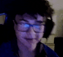 a close up of a person wearing glasses and headphones on a video call .