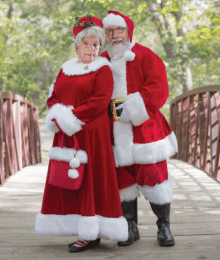 a man and a woman dressed as santa claus and mrs claus