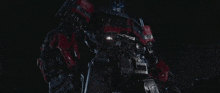 a close up of a robot in the dark with the word transformers on it