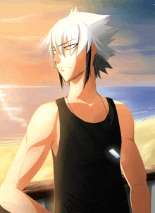 a man in a black tank top stands in front of a beach