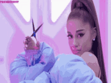 ariana grande is holding a pair of scissors