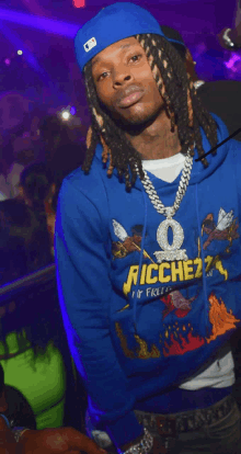 a man wearing a blue hoodie that says richezz