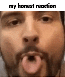 a close up of a man 's face with his tongue sticking out and the words `` my honest reaction '' above him .