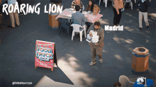 a man is carrying a tray of food in front of a sign that says " food truck day "