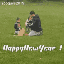 a man and two children are playing with a cat in a field and the caption says happy new year !