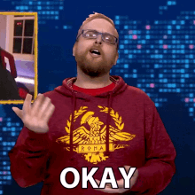 a man in a red hoodie that says okay