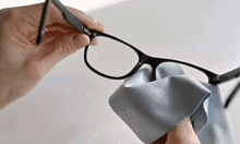 a person cleaning a pair of glasses with a cloth that says i smile