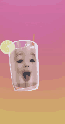 a baby 's face is in a glass with a straw